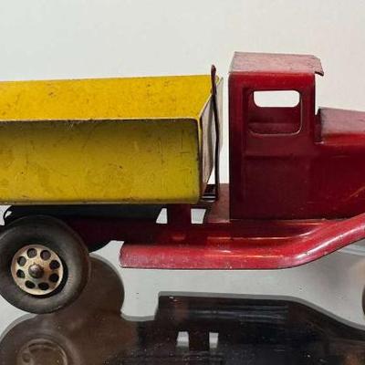 Vintage pressed steel dump truck with wood wheels
