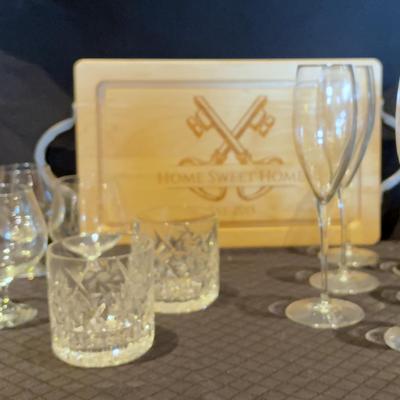 Cut Crystal Old Fashioned Glasses, Brandy Glasses, Champagne Flutes, And Wooden Cutting Board