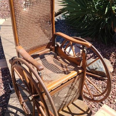 Roll Back in Time – Antique Wooden Wheelchair with Cane Seat and Back