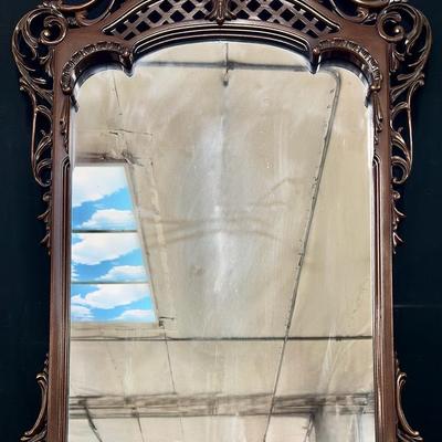 ornate carved wood-framed mirror