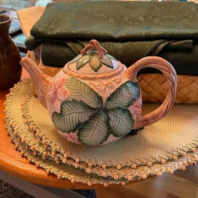 Brown Table Spinner, Placemats,Table Runners, Pink Flower Tea Pitcher, Woven Basket And Brown Vase n
