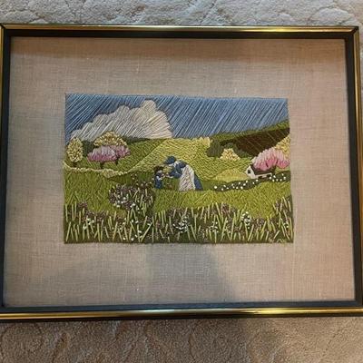 The image displays a framed piece of vintage crewel embroidery And 4 Plastic Wall Plaques 