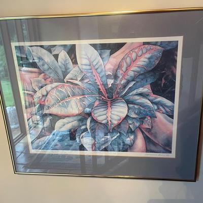 The image displays a framed art print featuring tropical leaves, likely a Betty Neubauer signed and 