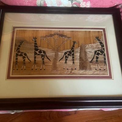 Giraffe picture made with elephant grass banana leaves and corn husks 