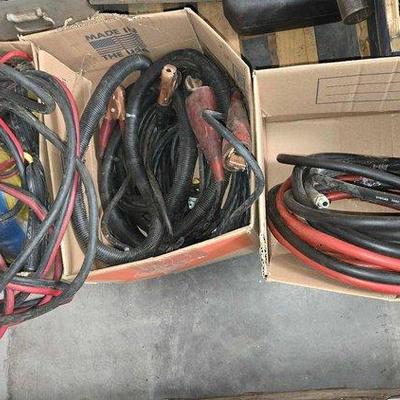 2670 • (3) boxes of pressue water hose & jumper cables