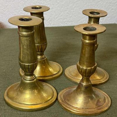 Four 19th century brass candle sticks