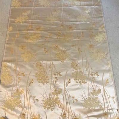 Yards of asian patterned satin on bolt fabric scraps