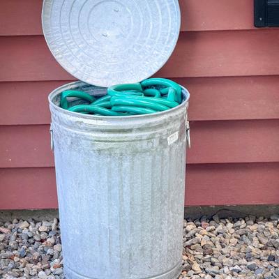 Aluminum Trash Can Full of Garden Hoses