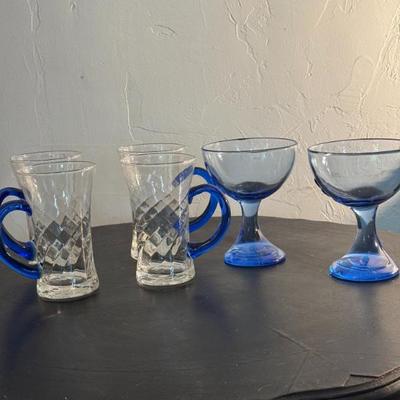 Four Mugs with Blue Handles and Two Goblets