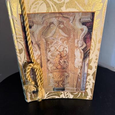 Hardcover Book with Rope Bookmark and Statue Depiction
