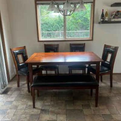 Dining room table set with four chairs and one bench