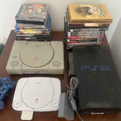 Four playstations five controllers and assortment of games