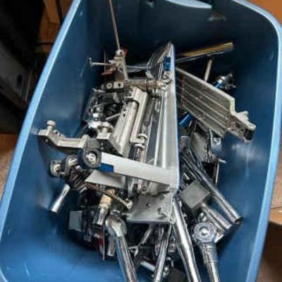 Crate full of drum stand parts clamps, accessories