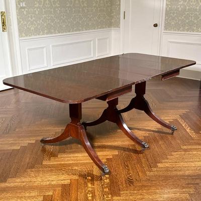 Duncan Phyfe Style Dining Table with Leaves | Vintage Duncan Phyfe style three pillar mahogany dining table with two drop leaf ends, four...