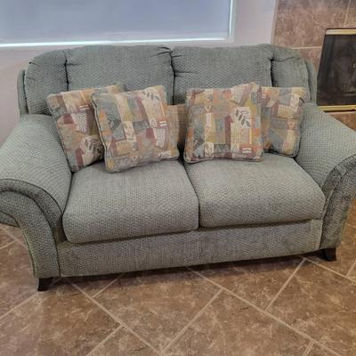 Green Loveseat Sofa with Rolled Arms and Accent Pillows