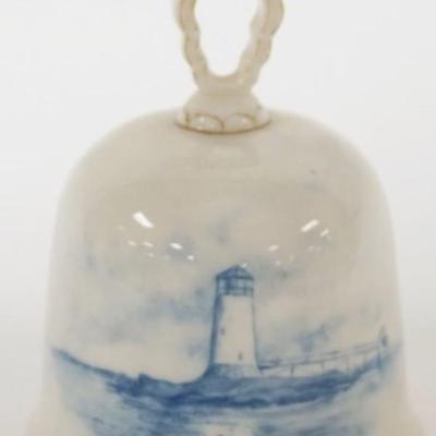 Sale Photo Thumbnail #128: 1128	CAC CERAMIC ART CO. BLUE AND WHITE AMERICAN BELLEEK BELL WITH IMAGE OF LIGHT HOUSE, APPROXIMATELY 4 1/4 IN H
