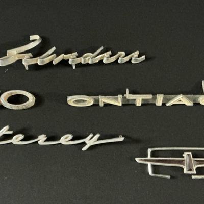 Various Broken Vintage Car Emblems