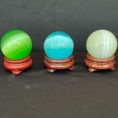 Three Crystal Balls on Wooden Stands