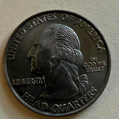 novelty coin featuring a humorous depiction of Bill Clinton and the phrase "BIRTHPLACE OF CLINTON" a