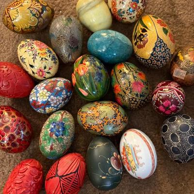 a large selection of stone and paper mache eggs