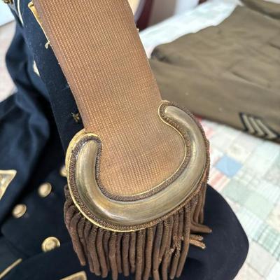 antique military items, including an 1880s US Navy dress tailcoat, epaulets, patches, and other jackets and headgear