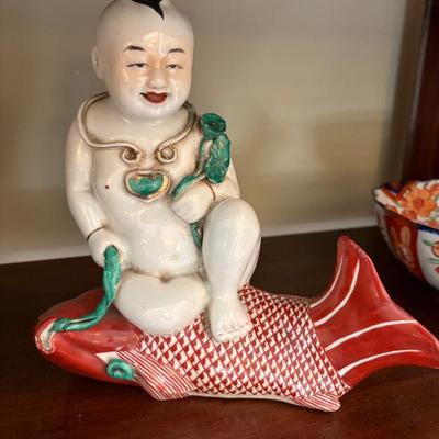 charming Chinese porcelain statue of a boy riding a carp