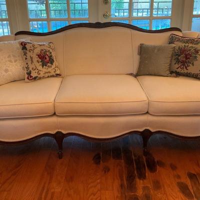Victorian Style Cream Upholstered Sofa With Wood Legs And Accent