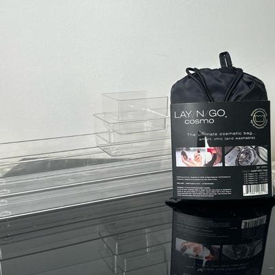 (2pc) Cosmetic Travel Bag & Acrylic Trays | "Lay/N/Go COSMO" cosmetic travel bag in the color "black," and...