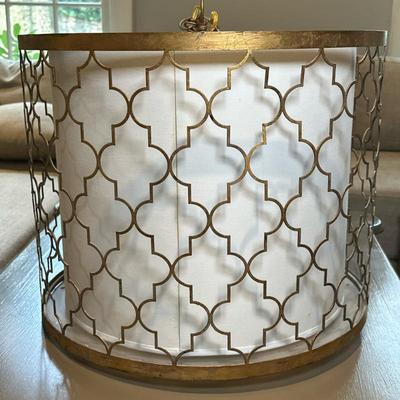 Geometric Cage Pendant Light | Modern geometric gold-gilt cage pendant light with a white drum lightshade, three-pronged lightbulb...