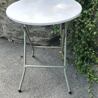 Round Folding Cocktail Table (2/2) | Round folding cocktail table with a white tabletop and gray steel frame, suitable for indoor or...