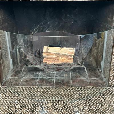 Curved Glass Fireplace Screen | Curved glass fireplace screen, offering a clear view of the flames, with central handle/hand-hold for...