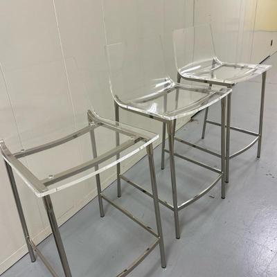 (3pc) Clear Acrylic Counter Stools | Minimalist bar stools crafted from a single piece of crystal-clear acrylic forming the seat,...