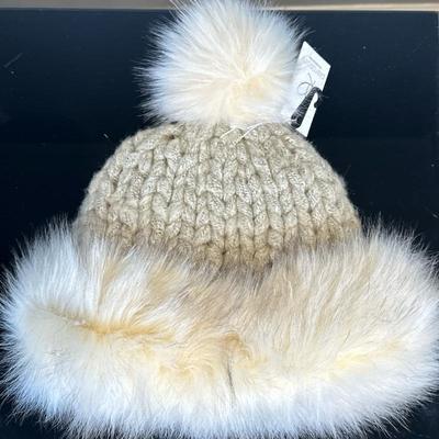 Pia Rossini Winter Hat | Pia Rossini cream-colored winter hat designed with a faux fur cuff and pouf on top.
