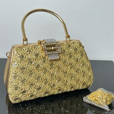 Gold Handbag with Chain Strap | Gold handbag with glittery lace-like texture, rhinestone buckle clasp, rounded top handle, and optional...
