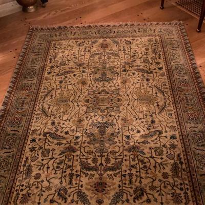 Area Rug - Oriental Design | Oriental style woven area rug with earth tones of brown and dark green and cream-colored tassels. Marked...