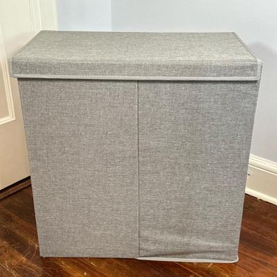 Dual Compartment Laundry Hamper | Dual-compartment laundry hamper in gray fabric/material with side handles. - h. 25.5 x w. 25 x d. 14.5 in
