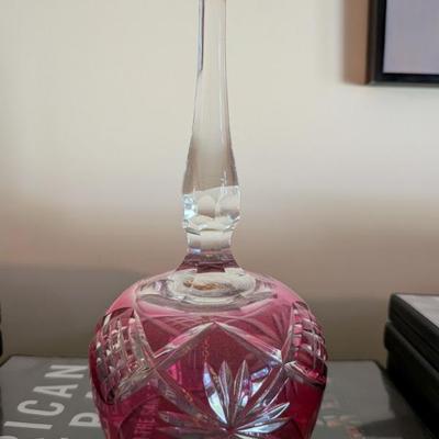 This is a beautiful decorative glass bell, likely from the mid-20th century. The bell features a stunning ruby red color with an elegant...