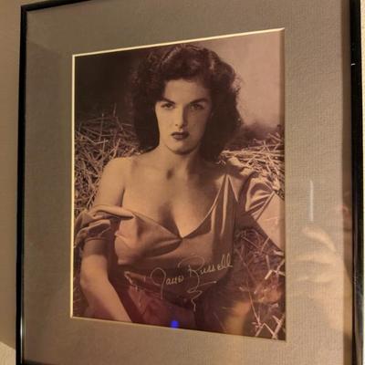 Framed black-and-white photo with a signature that appears to be from Jane Russell, a legendary actress and pin-up model.