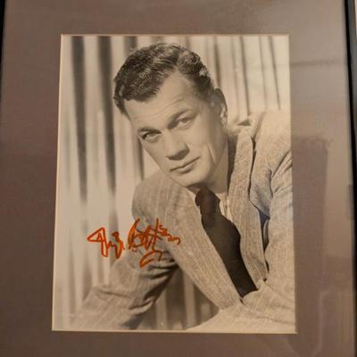 Framed black-and-white photo with a signature that appears to be from Joseph Cotten, a versatile actor known for his collaborations with...