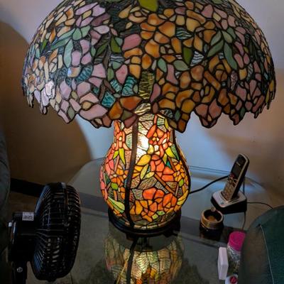 This is a magnificent and artistic table lamp in the iconic Tiffany style. The lampshade and the base are both crafted from beautiful,...