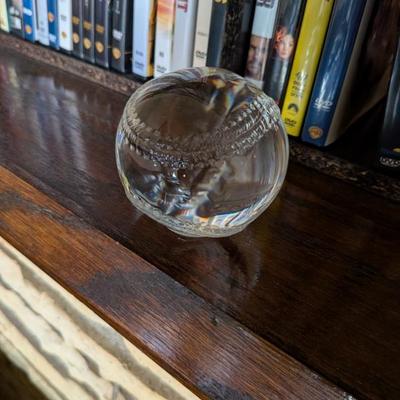 A unique and decorative piece for any baseball fan or desk! This is a solid, clear glass paperweight shaped and etched like a baseball....