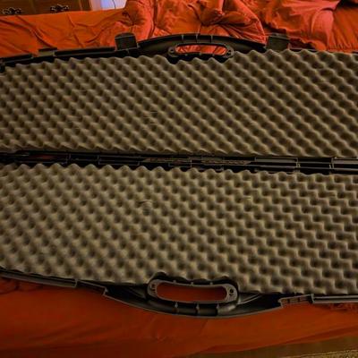 This is a heavy-duty, hard-shell gun case, likely capable of holding two rifles or shotguns. With its rugged construction and thick,...
