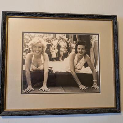 A truly iconic piece of Hollywood history! This framed, black-and-white photo captures the legendary Marilyn Monroe and Jane Russell...