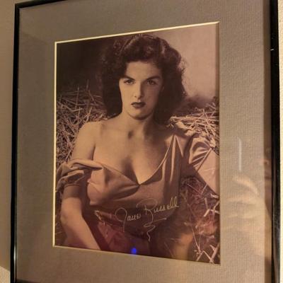 Framed black-and-white photo with a signature that appears to be from Jane Russell, a legendary actress and pin-up model.