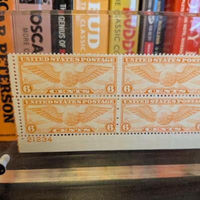 This is a fantastic piece of vintage Americana and philatelic art. The clear acrylic frame beautifully showcases a complete block of four...