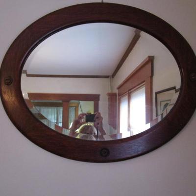 Oak framed oval mirror - Glass is beveled.. Dimensions 28"Hx24"W