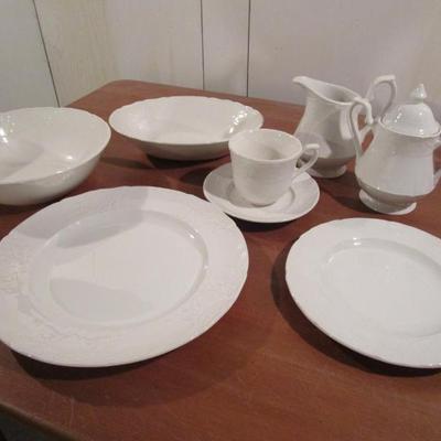 Sale Photo Thumbnail #96: China - All white with lacy design, Microwave and dishwasher safe, 8 place settings (dinner plate, salad plate, teacup and saucer), cream and sugar, 2 serving bowls, 1 platter.   Perfect condition.  Would look great today on any table.
