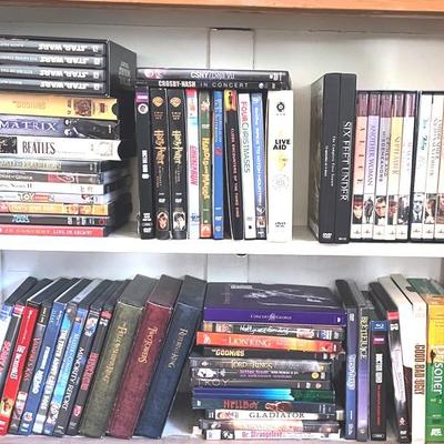 Two Shelves Of DVDs And VHS Movies 
