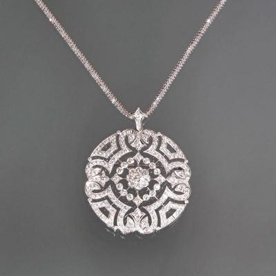 DIAMOND & 18K WHITE GOLD OPENWORK ENHANCER BROOCH | An openwork 18k white gold enhancer pendant/pin set with round diamonds, the...