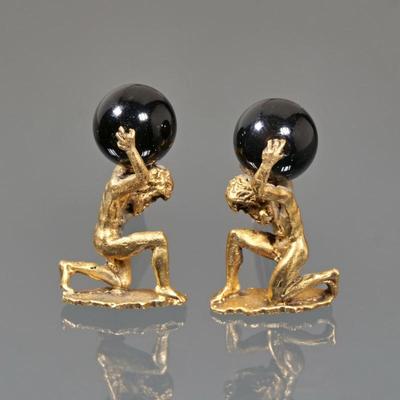 ATLAS ONYX & 14K GOLD FIGURAL CUFFLINKS | A pair of 14k yellow gold cuff links depicting the Greek god Atlas bearing an onyx (or...